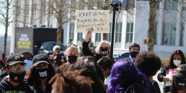 Dozens of demonstrators rallied Thursday across the street from the Georgia Capitol, protesting GOP voting bills.