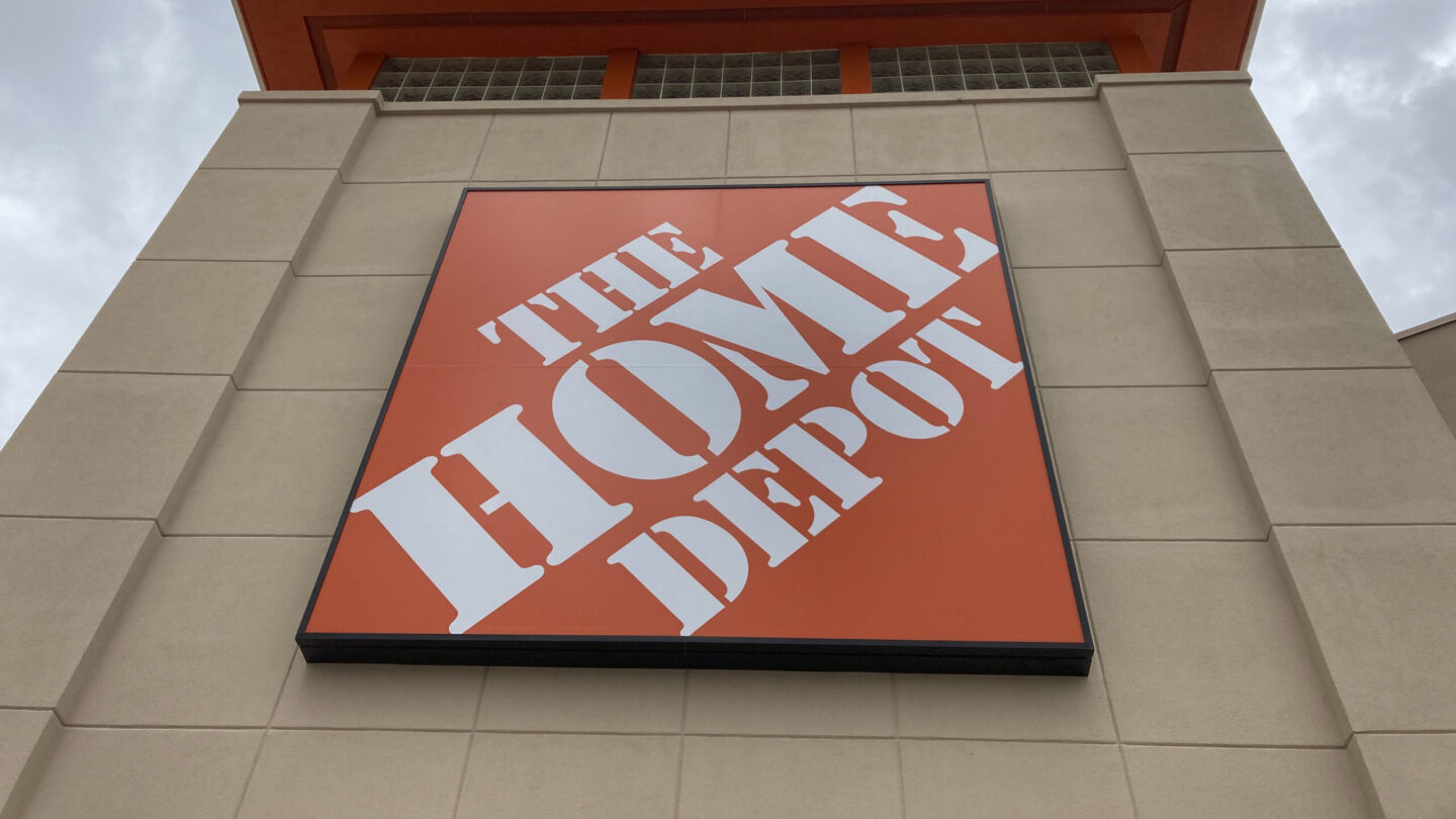 Home Depot's second-quarter sales rose slightly as the nation's biggest Atlanta company benefitted from an $18 billion acquisition this spring, but customers continued to rein in spending because of broadly higher costs and elevated interest rates.