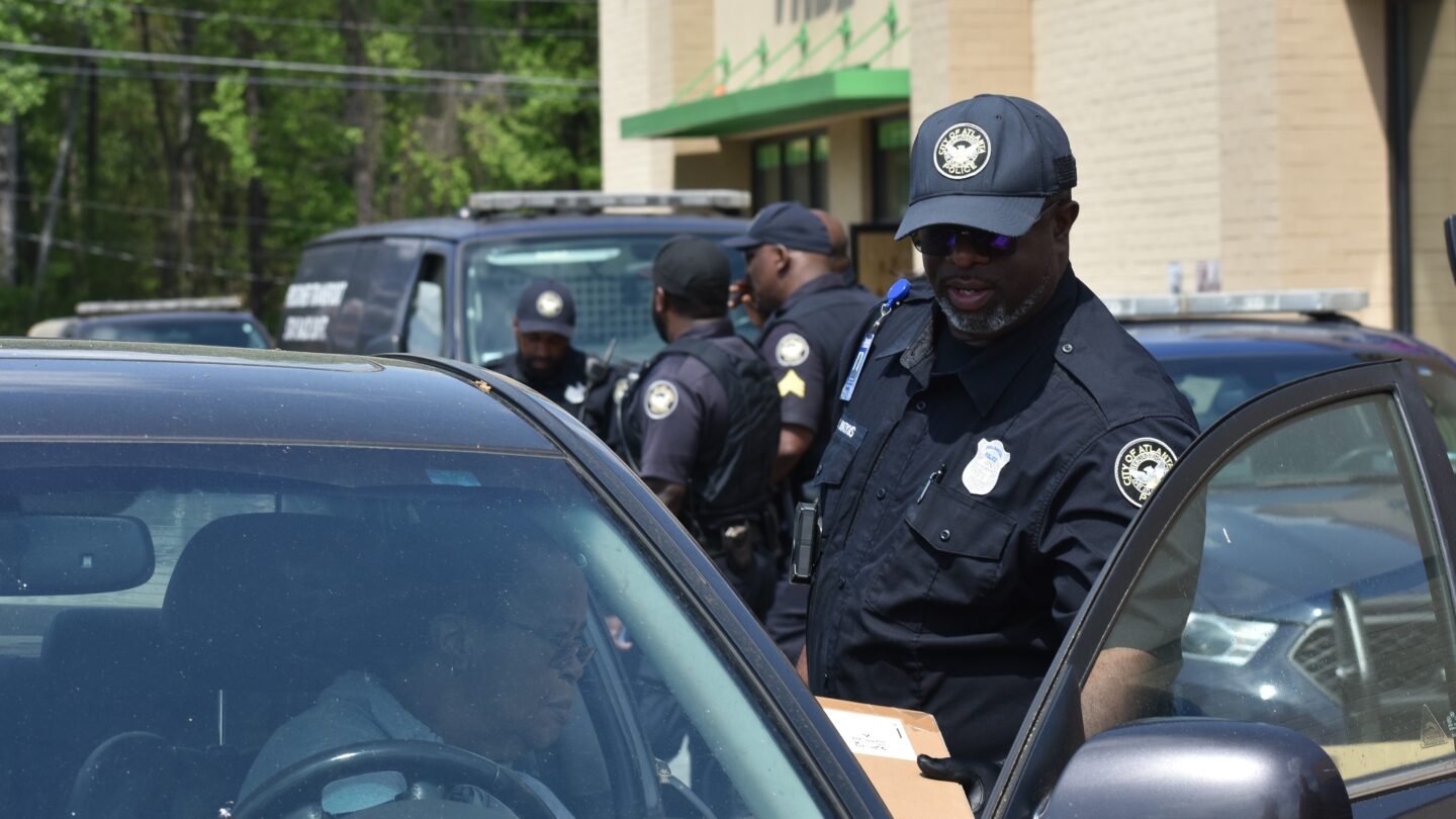 Atlanta Policman talking to man in car