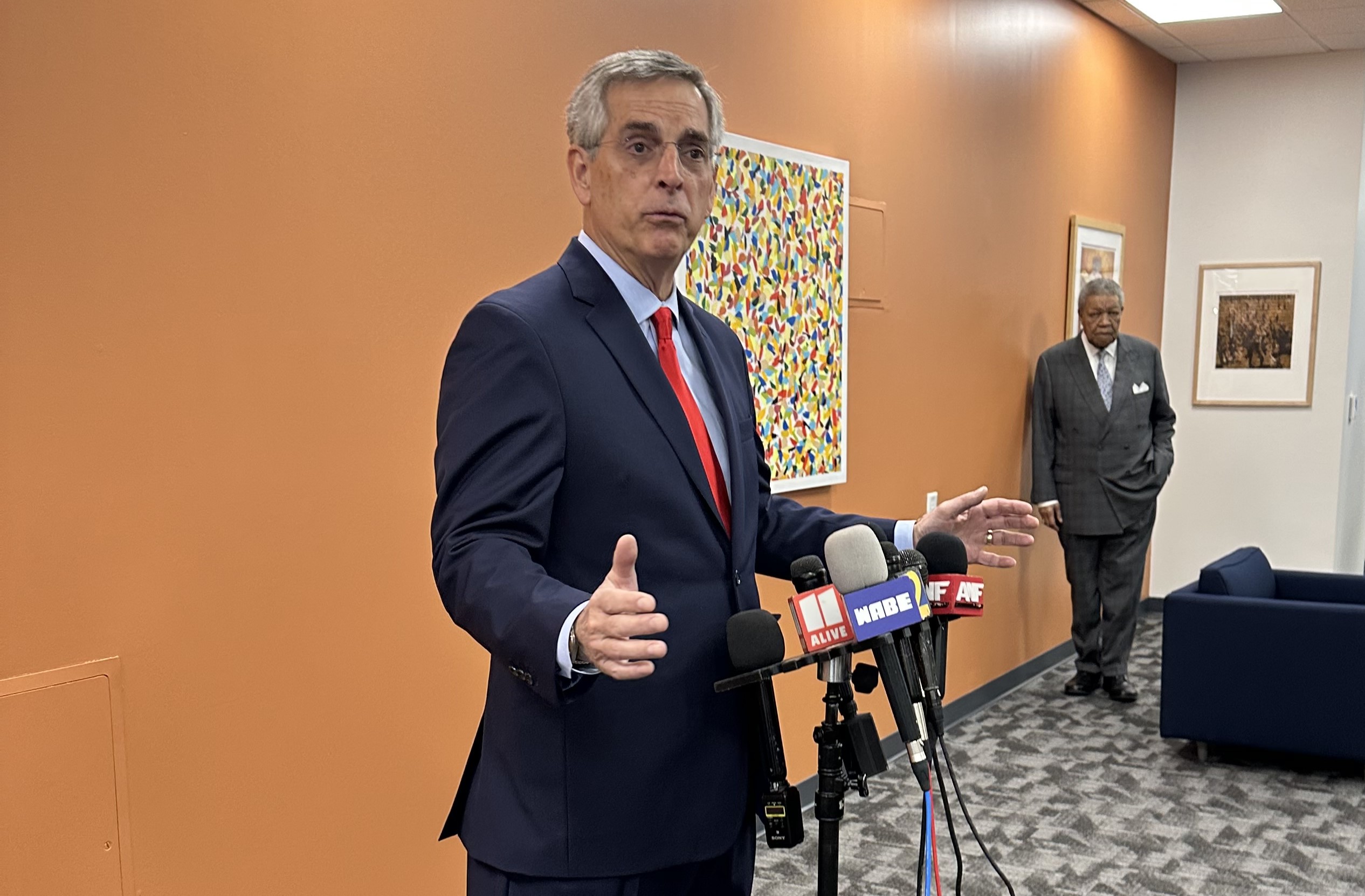 Georgia Secretary of State Brad Raffensperger held a press conference on Thursday, Nov. 9, 2023, about a suspicious letter sent to the Fulton County Elections Office in Fairburn. He stands in an orange room.