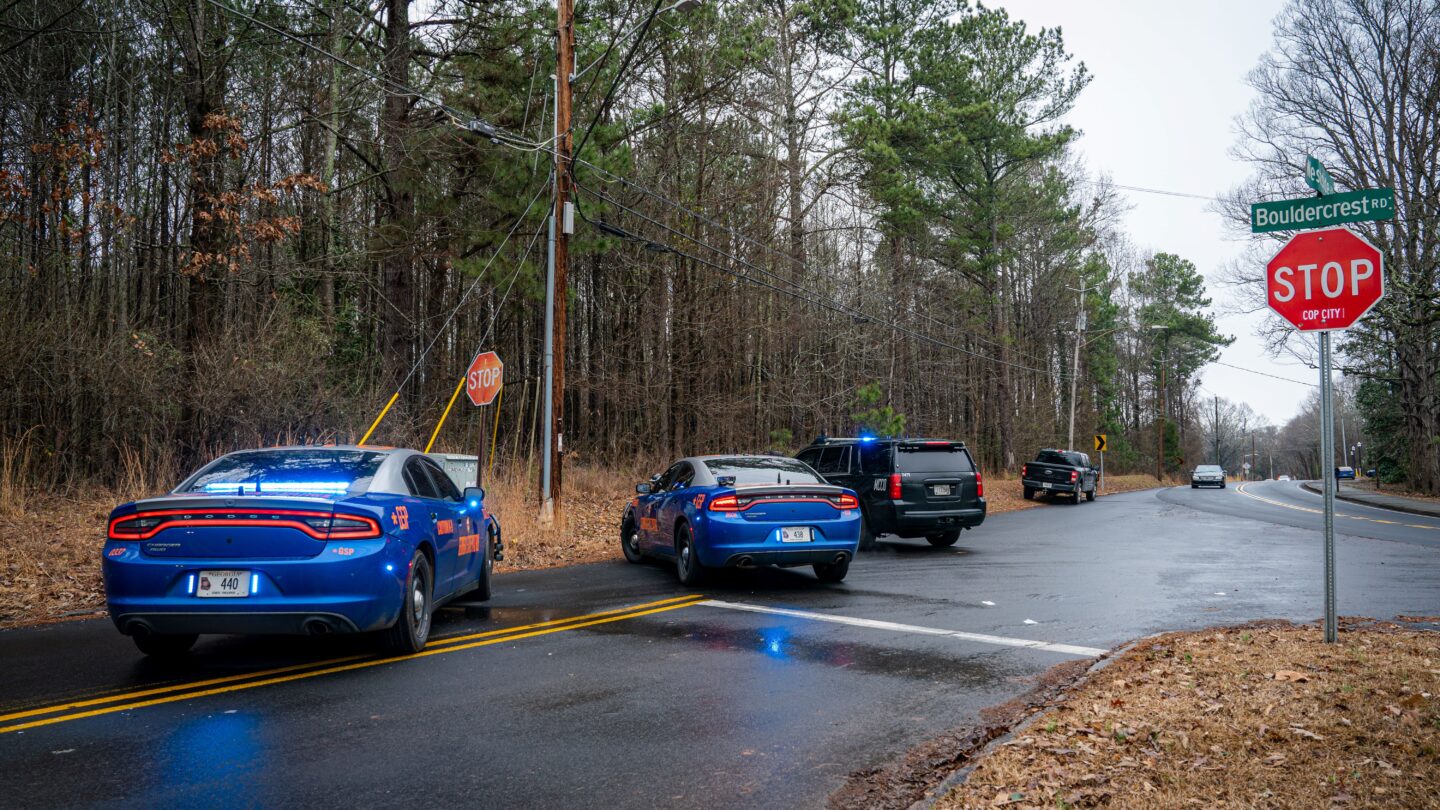 Police Cars parked on road intersection