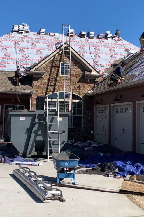 House under constrution with roofing materials on top