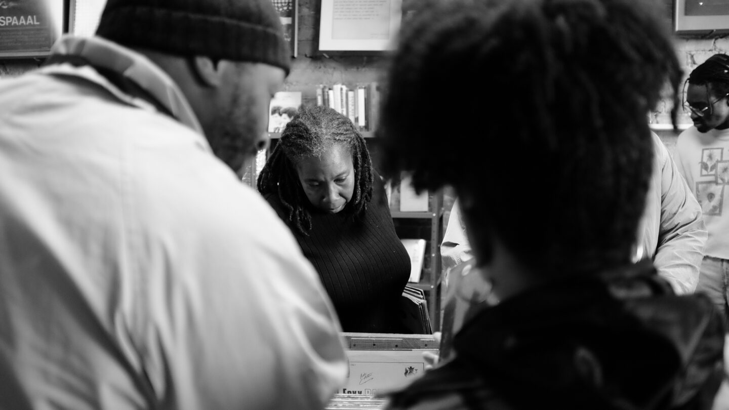 Black and white photo of people browsing records