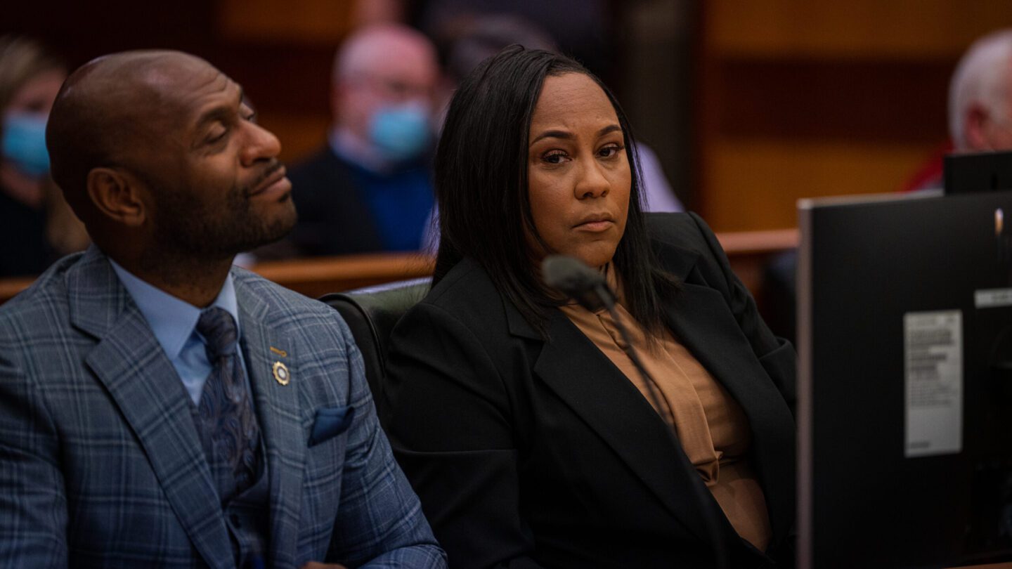 Two adults sitting in court