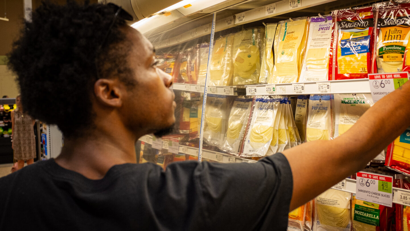 Youn man selecting groceries