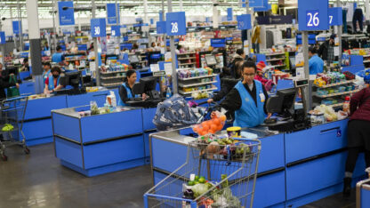 Cashiers process purchases at a Walmart Supercenter in North Bergen, N.J., on Feb. 9, 2023.