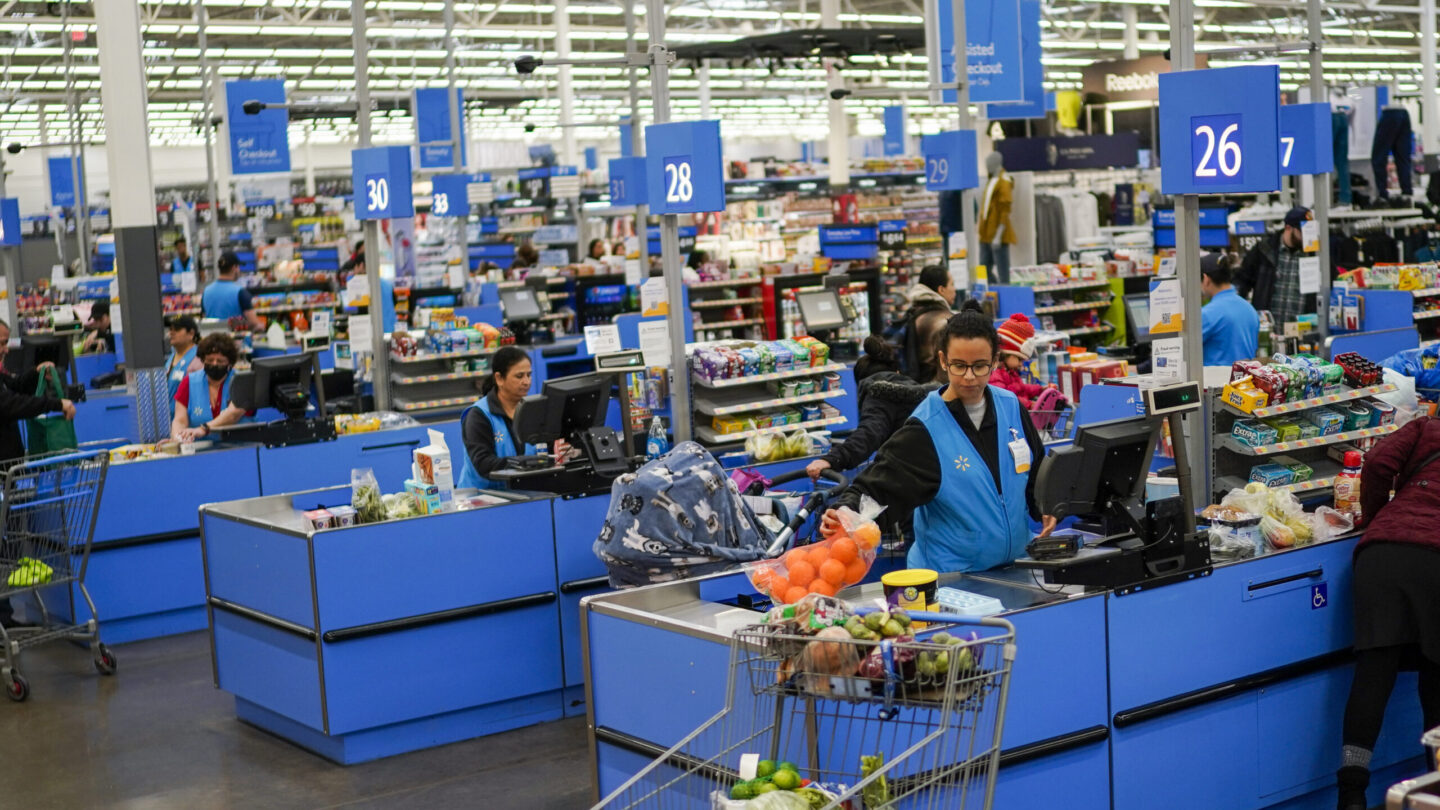 Cashiers process purchases at a Walmart Supercenter in North Bergen, N.J., on Feb. 9, 2023.