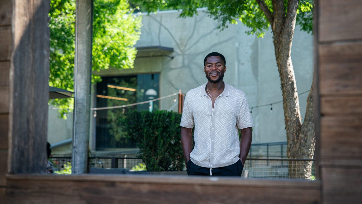 Young man smiling outside