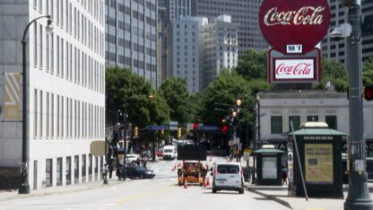 A view shows Peachtree Street in Atlanta on June 10, 2022. A large Coca-Cola sign stands in the far right corner of the photo.