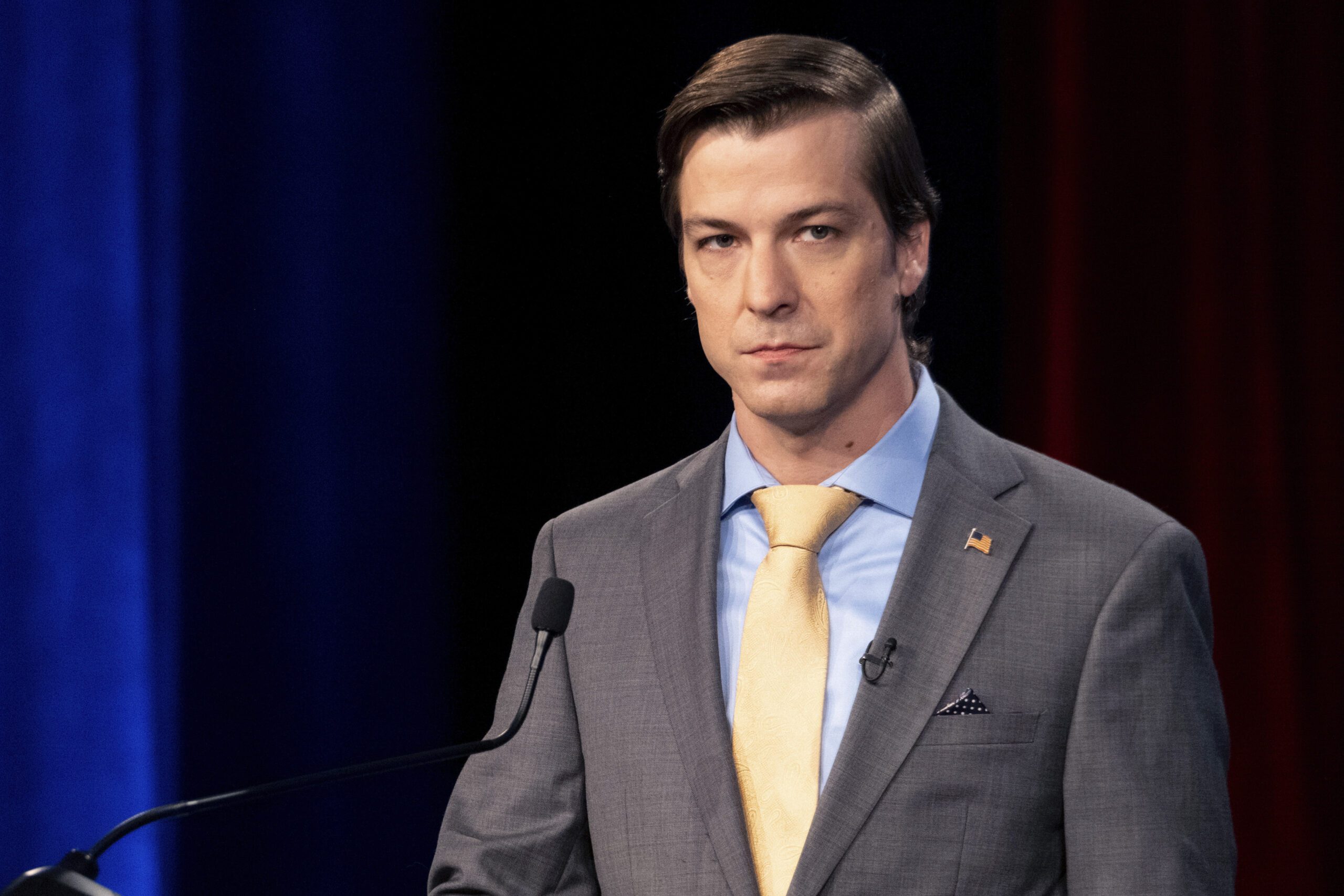 Libertarian Chase Oliver stands at the podium of a U.S. Senate debate in Atlanta.