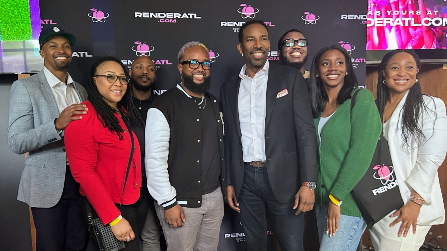 A group of tech leaders are gathering in front on a Render ATL backdrop for a photo.