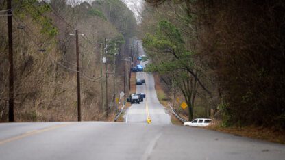 Multiple law enforcement agencies form a perimeter along Constitution Rd after a Trooper was shot and a protester was killed in the Atlanta Forest.