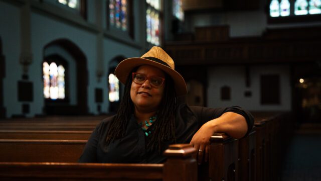 Kim Jackson, Georgia's first openly gay senator, sits in a pew at St. Luke's Episcopal Church in Atlanta.