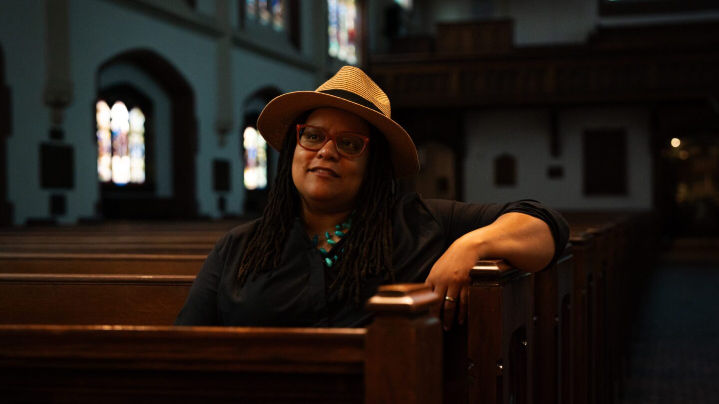 Kim Jackson, Georgia's first openly gay senator, sits in a pew at St. Luke's Episcopal Church in Atlanta.