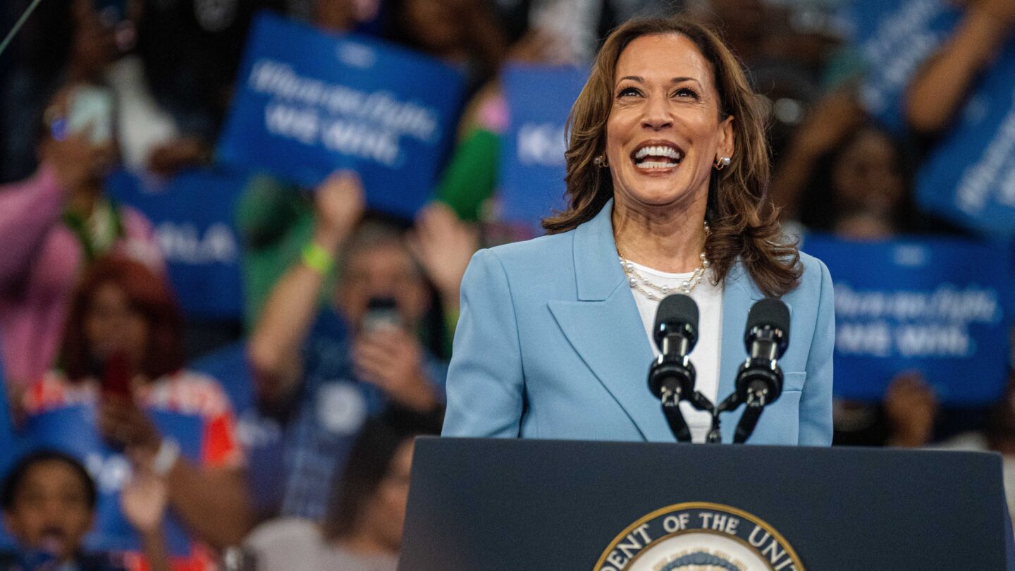 Kamala Harris faces the cheering crowd with a smile at a presidential campaign rally at the Georgia State University Convocation Center.