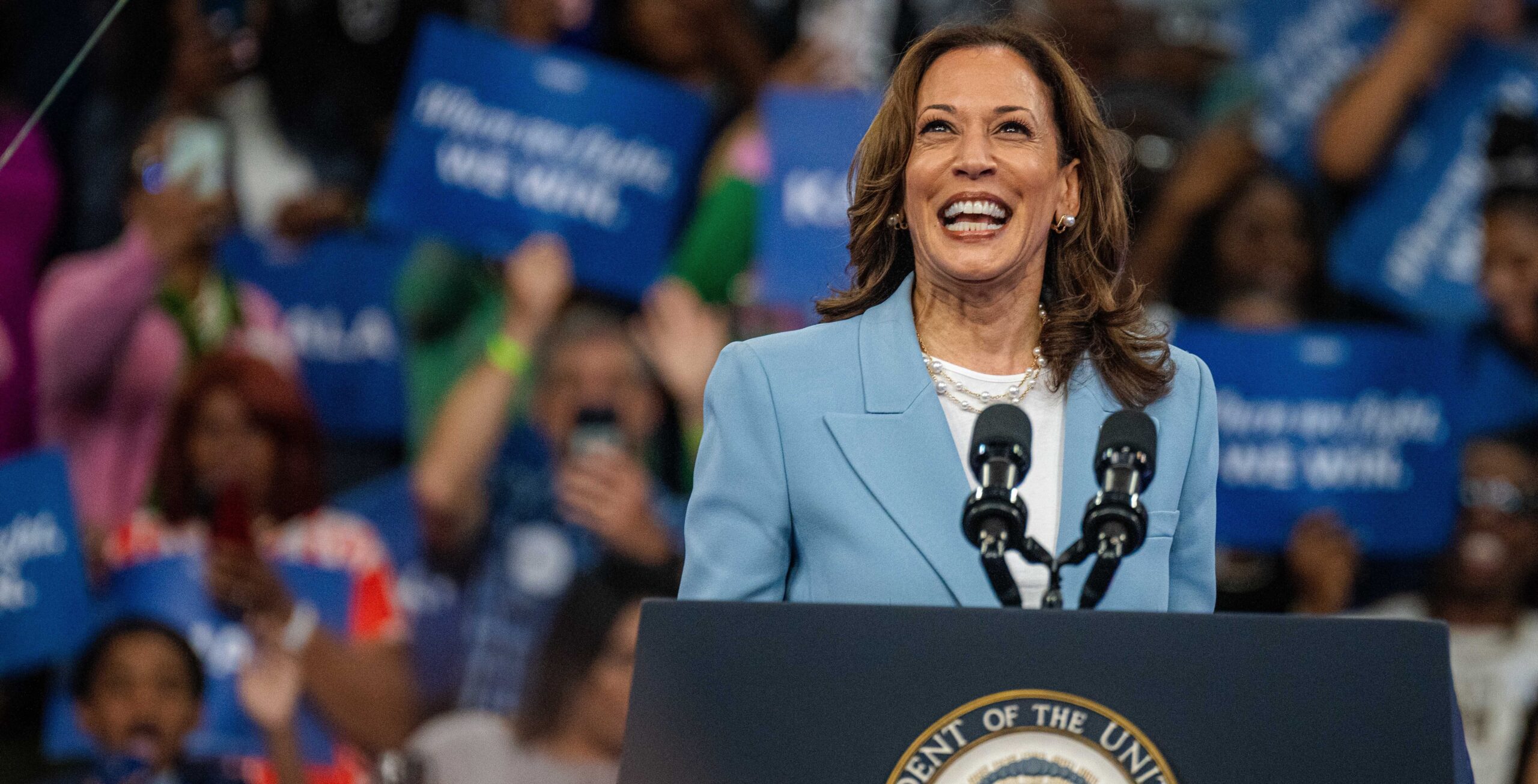 Kamala Harris faces the cheering crowd with a smile at a presidential campaign rally at the Georgia State University Convocation Center.