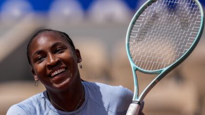 Coco Gauff of the U.S. attends a practice session ahead of the tennis competition, at the 2024 Summer Olympics, Thursday, July 25, 2024, in Paris, France. She is smiling and holding a tennis racket.