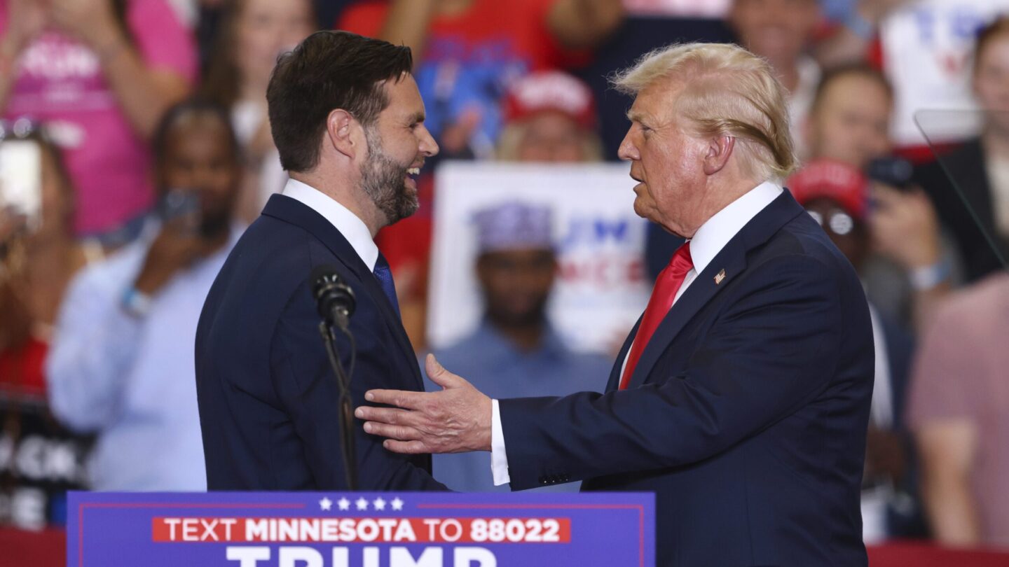 Republican presidential candidate former President Donald Trump and Republican vice presidential candidate Sen. JD Vance, R-Ohio, greet each other at a campaign rally, Saturday, July 27, 2024, in St. Cloud, Minn.