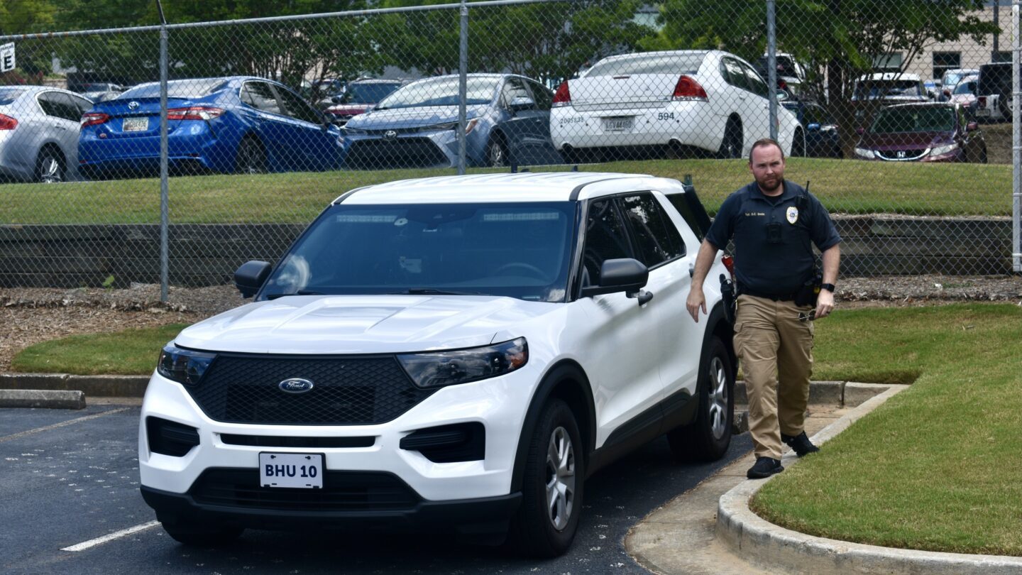 Policeman by white SUV