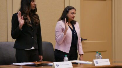 Dr. Aisvarya Panakam stands to the left and Dr. Suchitra Chandrasekaran stand on the right as they are sworn in Tuesday at a Senate subcommittee field hearing at Decatur City Hall.