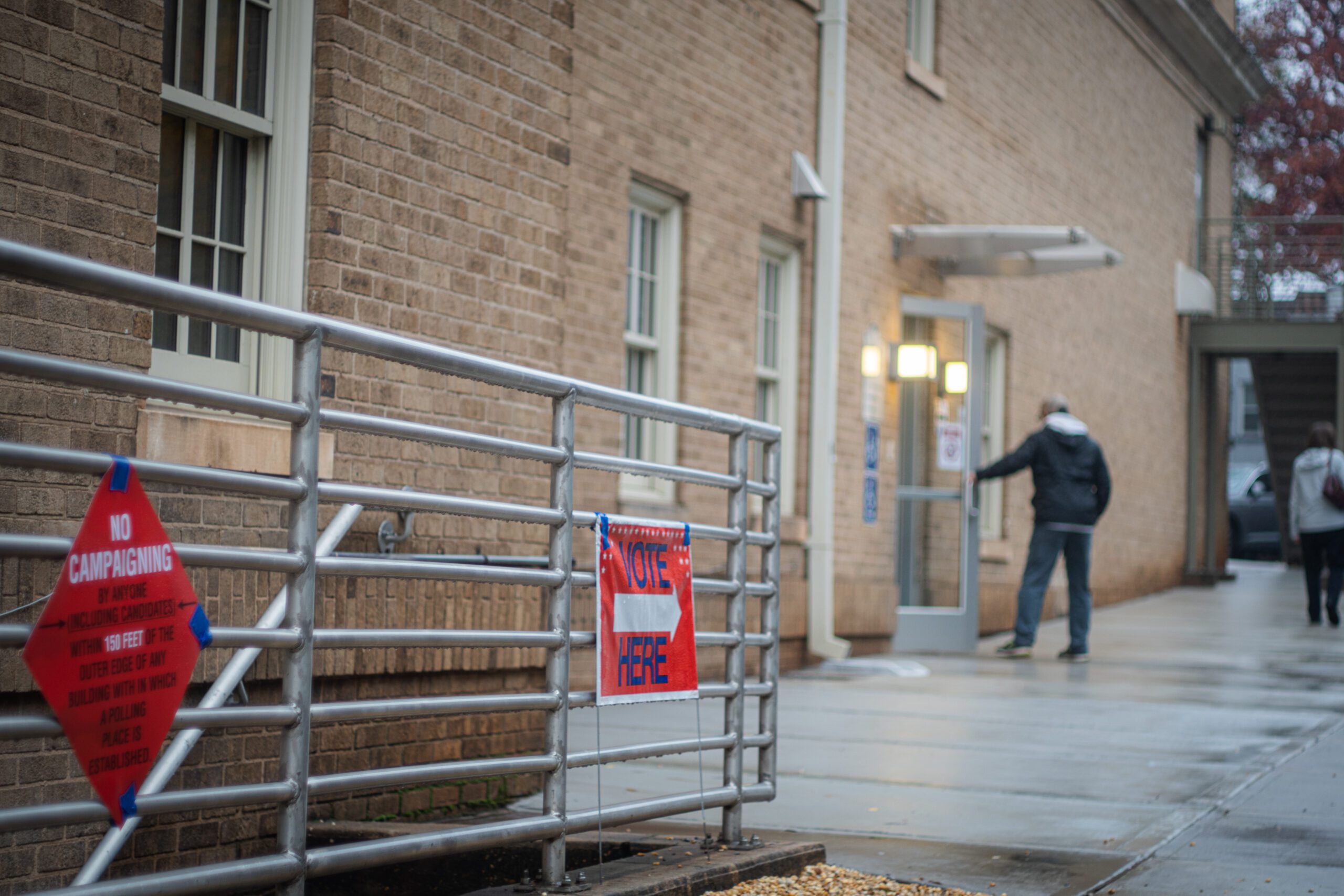 A voter opens the door to a polling site.