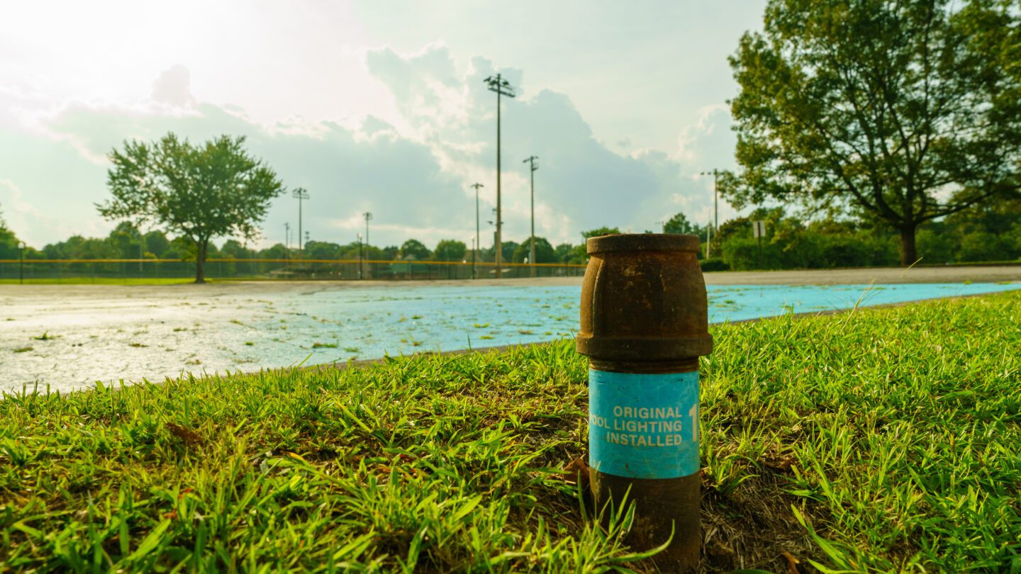 Old pool lighting equipment and a blue painted rectangle outlines where a segregated pool in East Point once existed.