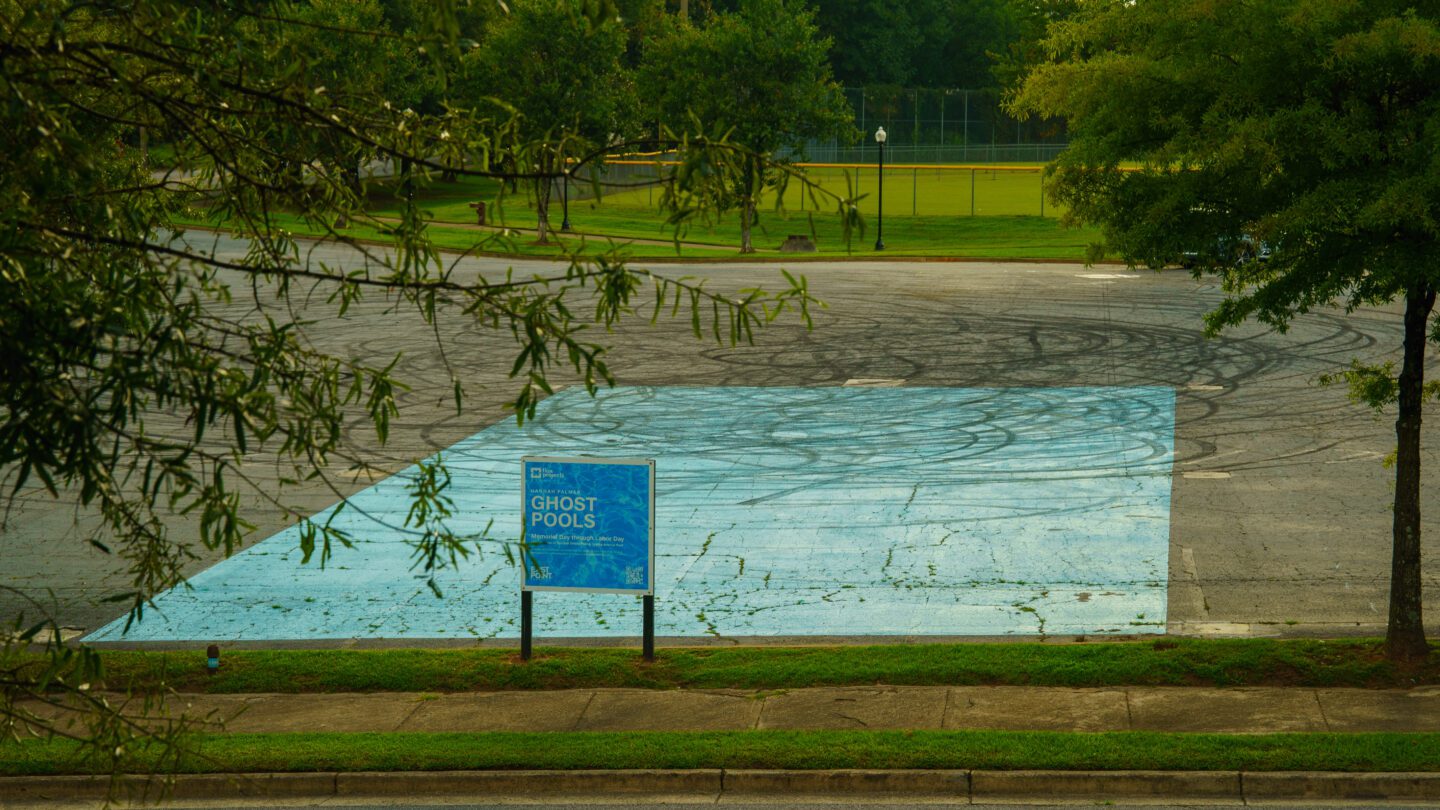 A blue painted rectangle in a parking lot outlines where a segregated pool in East Point once existed.