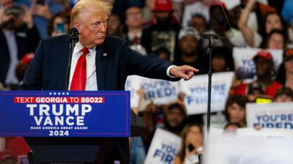 Former President Donald Trump points at the crowd at his campaign rally in Atlanta on Saturday, Aug. 3, 2024.