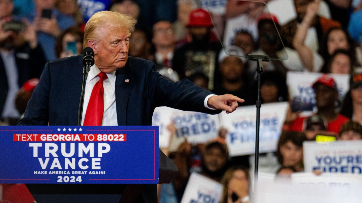 Former President Donald Trump points at the crowd at his campaign rally in Atlanta on Saturday, Aug. 3, 2024.