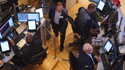 An overhead perspective of traders working on the floor of the New York Stock Exchange.
