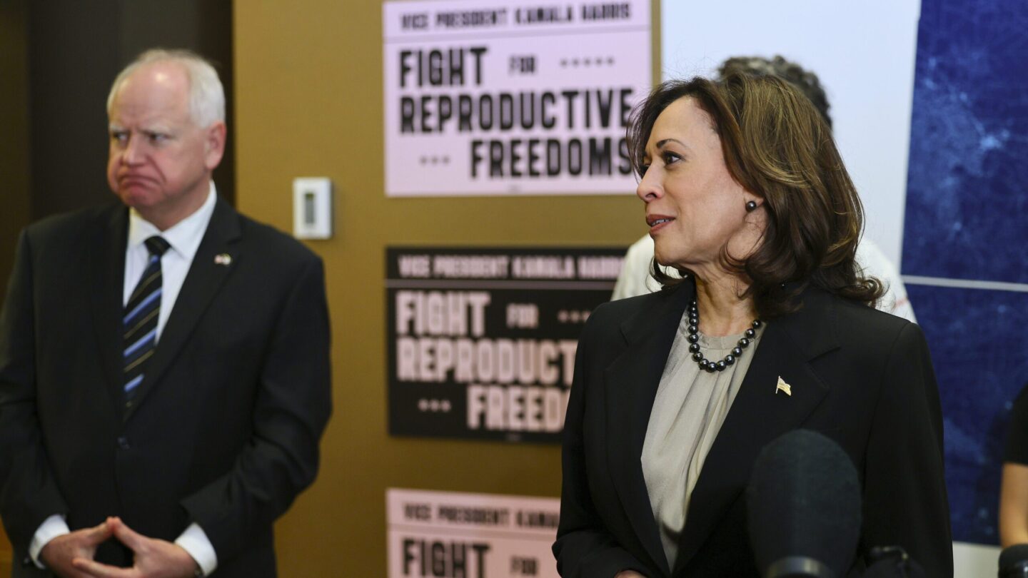 Minnesota Governor Tim Walz listens to Vice President Kamala Harris speak at Planned Parenthood.