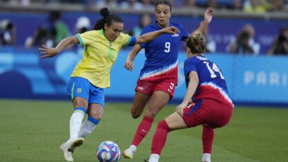 Brazil's Marta, left tries to get past Mallory Swanson of the United States, center and Emily Sonnett during the women's soccer gold medal match between Brazil and the United States.