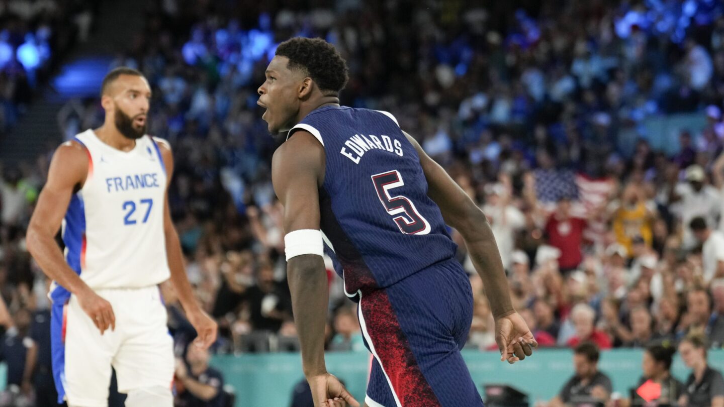 Anthony Edwards runs across the court in celebration of a basket against France. The back of his jersey shows his last name and his number, 5.