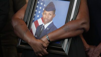 Chantemekki Fortson, mother of slain Roger Fortson, a U.S. Air Force senior airman, holds a large framed photo of her son during a news conference with attorney Ben Crump