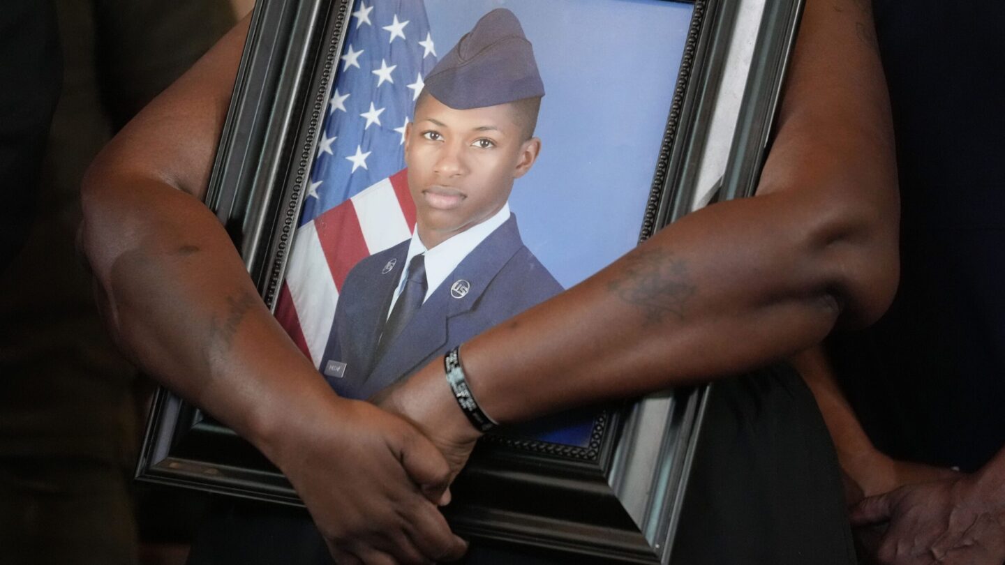 Chantemekki Fortson, mother of slain Roger Fortson, a U.S. Air Force senior airman, holds a large framed photo of her son during a news conference with attorney Ben Crump