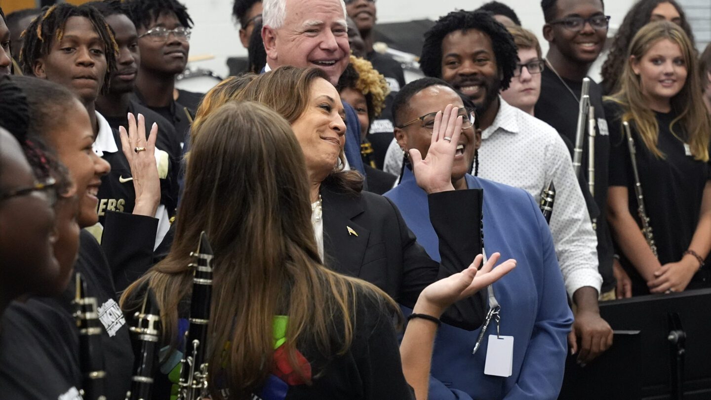 Democratic presidential nominee Vice President Kamala Harris and Democratic vice presidential candidate Minnesota Gov. Tim Walz poses for a photo with marching band members at Liberty County High School in Hinesville, Ga.