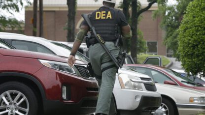 A Drug Enforcement Administration officer patrols outside of a medical clinic in Little Rock, Ark