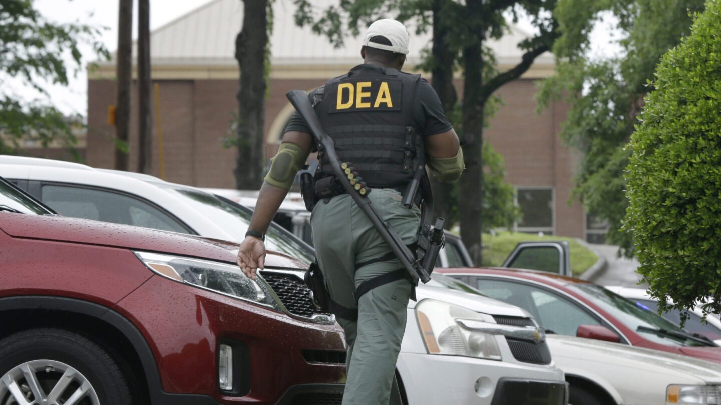 A Drug Enforcement Administration officer patrols outside of a medical clinic in Little Rock, Ark