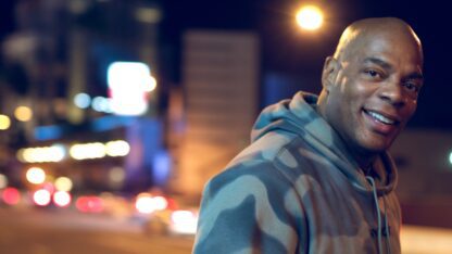 Alonzo Bodden standing in front of a street at night.