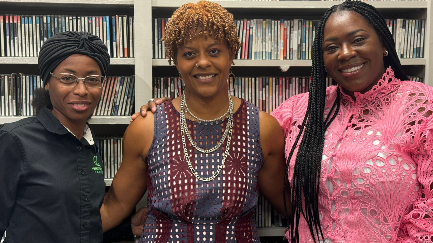 Alicia Rivera, the CFO of Feeding Georgia Families, Giving GAP CEO Heather Infantry and Mallorye Crowell, the founder and President of The Higher Foundation pose for a photo in front of a bookshelf.