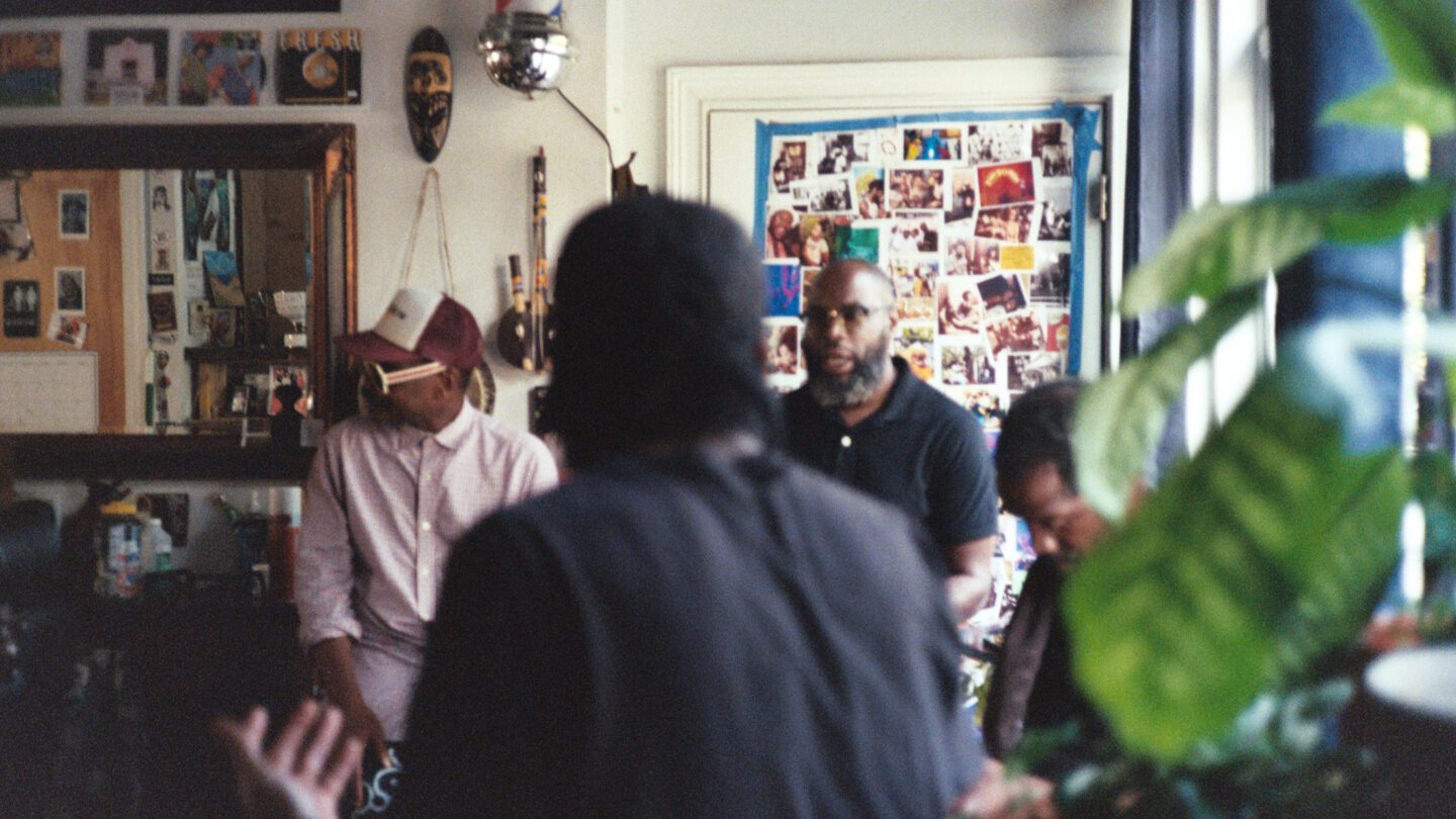 At the barbershop, Ernest Hood sits on the left, Javon Lee second from the left, Carlos York sits second on the right, and Devron Barrett is on the far right.