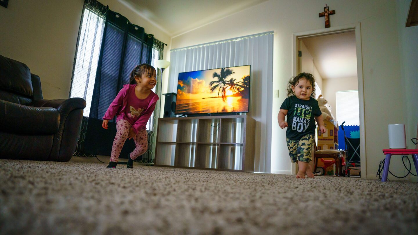 Martinez' youngest son and daughter play in their Kennesaw home.