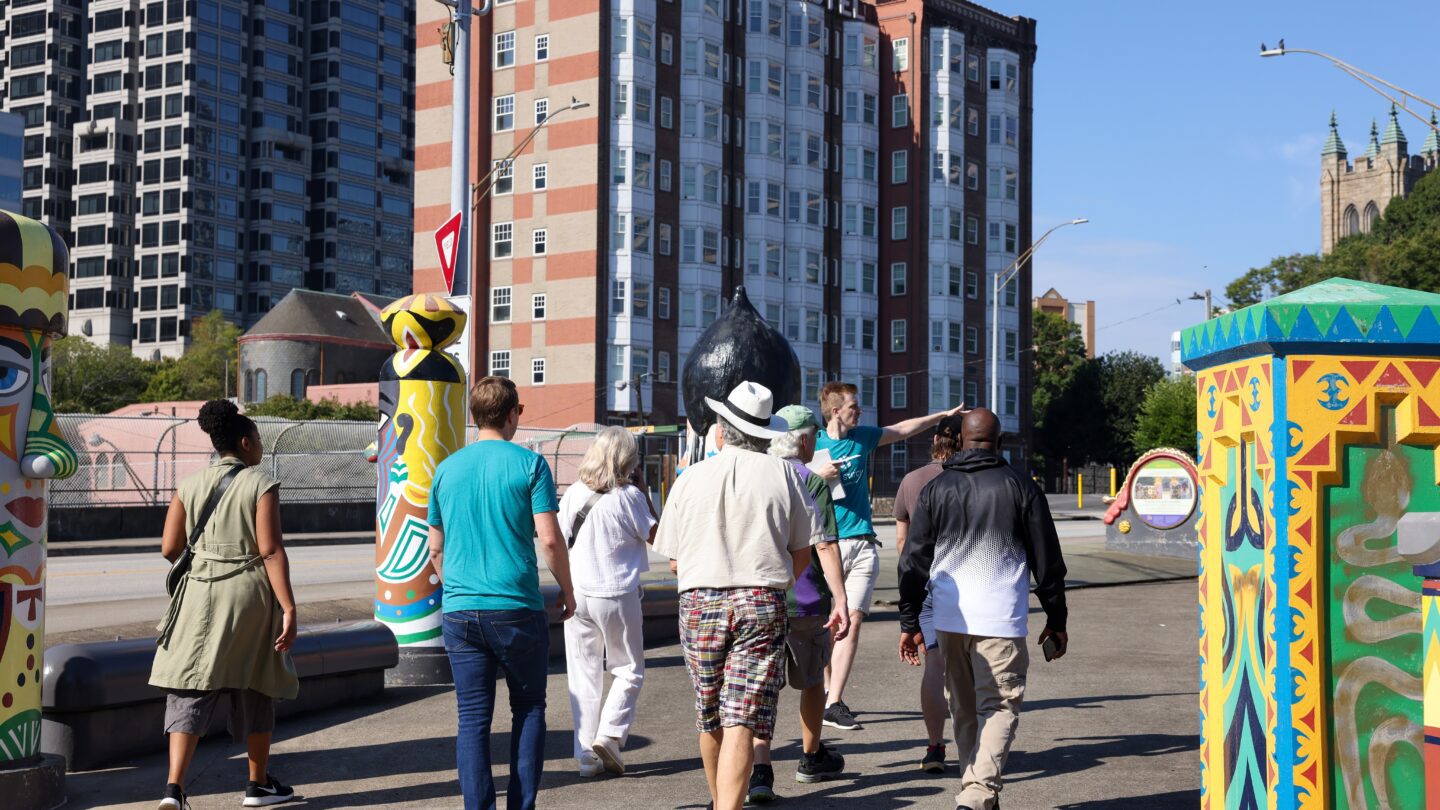 A group of people walking in Downtown Atlanta, on a tour of the area where the Stitch is planned.