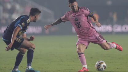 Lionel Messi kicks ball away from Leon Flach during MLS soccer match in Florida.