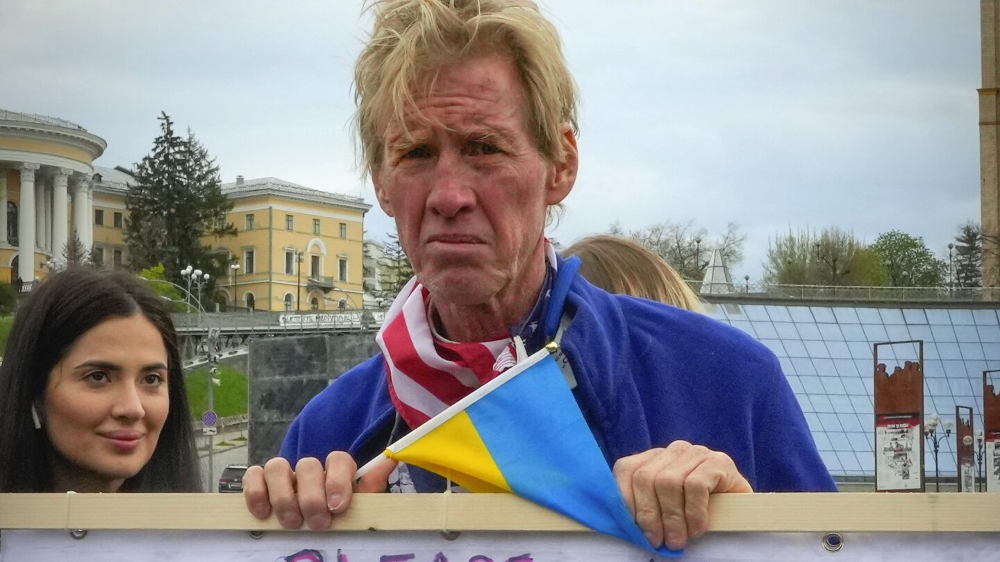 Ryan Wesley Routh holds up a sign at a rally in Ukraine.