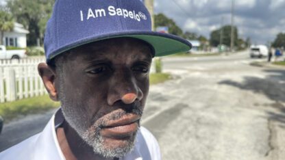 A resident of Sapelo Island wears a hat that reads I am Sapelo.