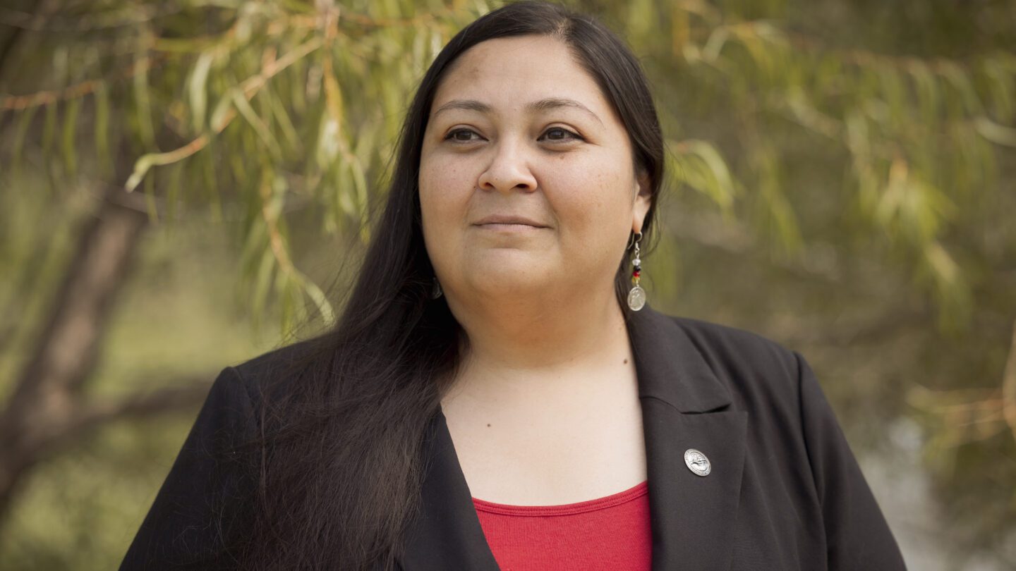 RaeLynn Butler, a Muscogee Nation citizen and one of its tribal historic preservation officers, poses for a photo outside.