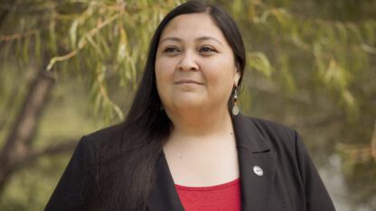 RaeLynn Butler, a Muscogee Nation citizen and one of its tribal historic preservation officers, poses for a photo outside.