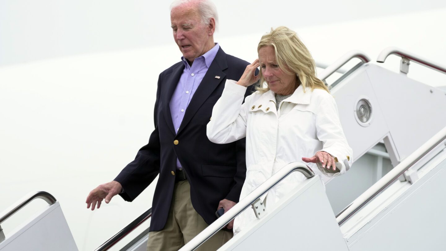 Joe and Jill Biden descend the stairs from Air Force One.