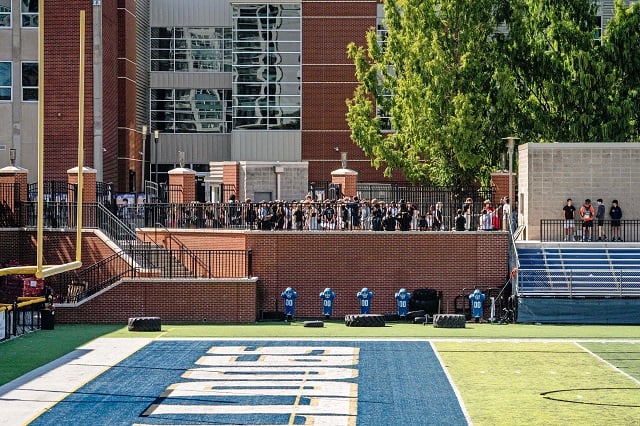 The Decatur High School stadium. Students are gathered in front of it.